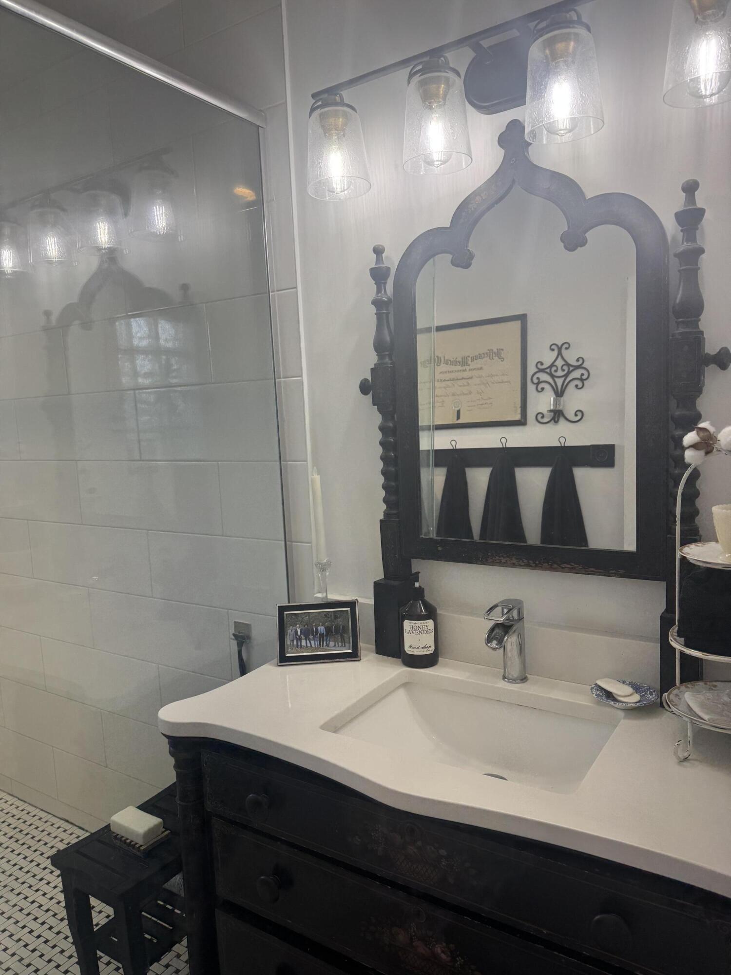 8933 Southeast Ceres Street Hobe Sound, FL 33455 - Photo 5 of 5 a bathroom with a sink and a mirror