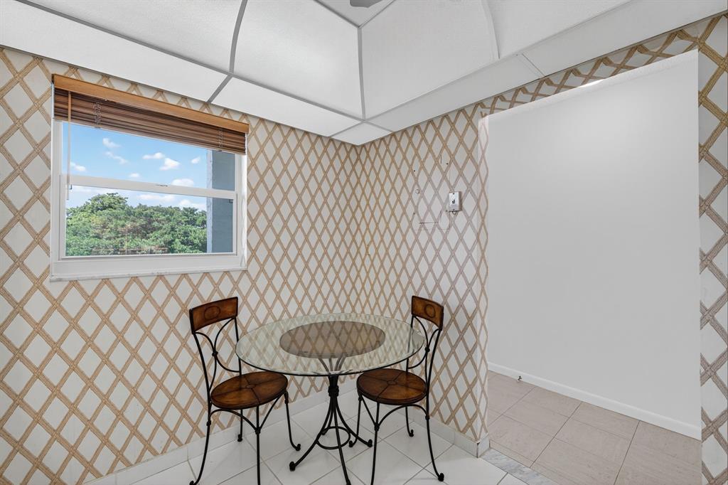 1541 South Ocean Boulevard, Unit 405 Lauderdale-by-the-Sea, FL 33062 - Photo 11 of 57 a view of a dining room with furniture window and wooden floor