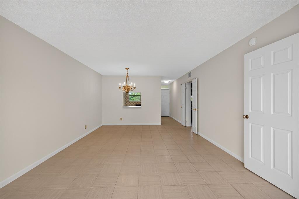1541 South Ocean Boulevard, Unit 405 Lauderdale-by-the-Sea, FL 33062 - Photo 14 of 57 an empty room with a window and a refrigerator