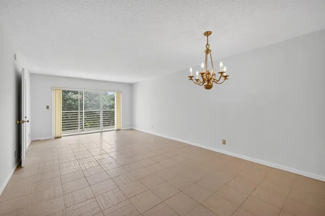 a living room with furniture a chandelier and a chandelier