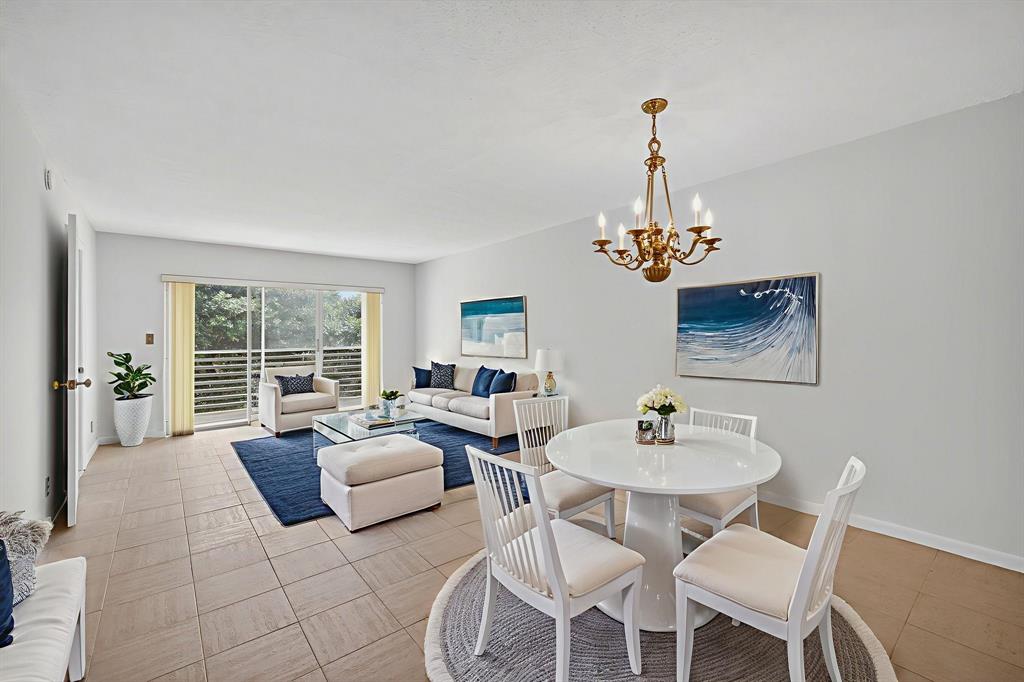 1541 South Ocean Boulevard, Unit 405 Lauderdale-by-the-Sea, FL 33062 - Photo 16 of 57 a living room with furniture a chandelier and a chandelier
