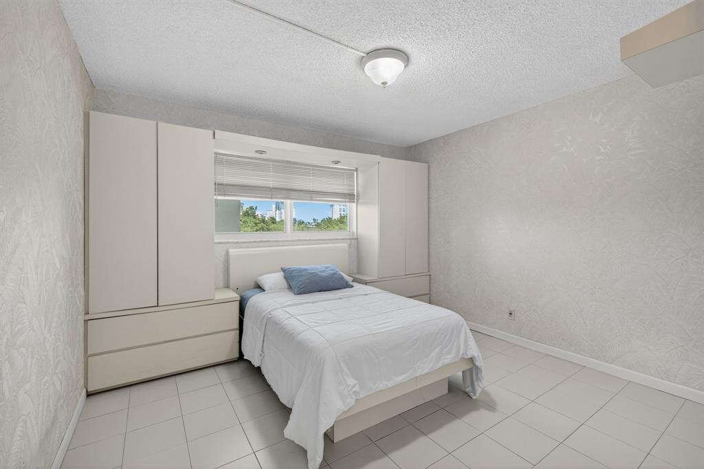 1541 South Ocean Boulevard, Unit 405 Lauderdale-by-the-Sea, FL 33062 - Photo 20 of 57 a bedroom with a bed and a window