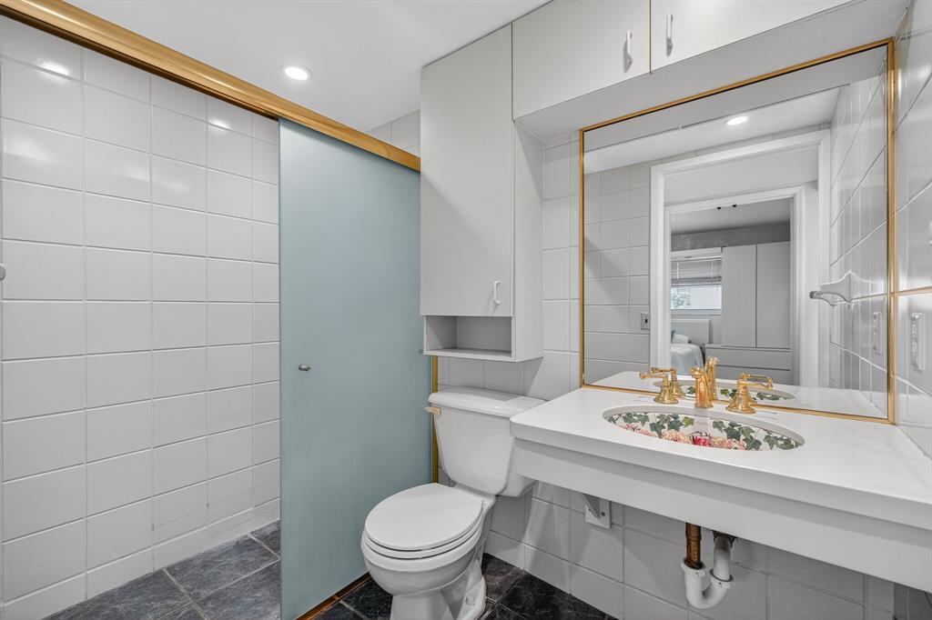 1541 South Ocean Boulevard, Unit 405 Lauderdale-by-the-Sea, FL 33062 - Photo 23 of 57 a bathroom with a sink a toilet and shower