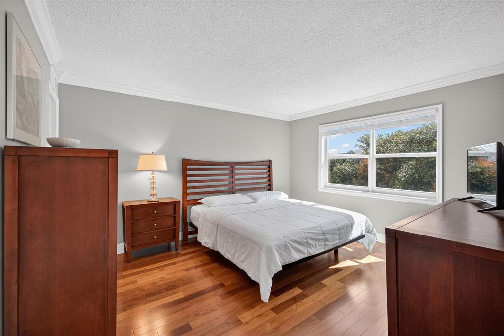 1541 South Ocean Boulevard, Unit 405 Lauderdale-by-the-Sea, FL 33062 - Photo 24 of 57 a bedroom with a bed window and a dresser