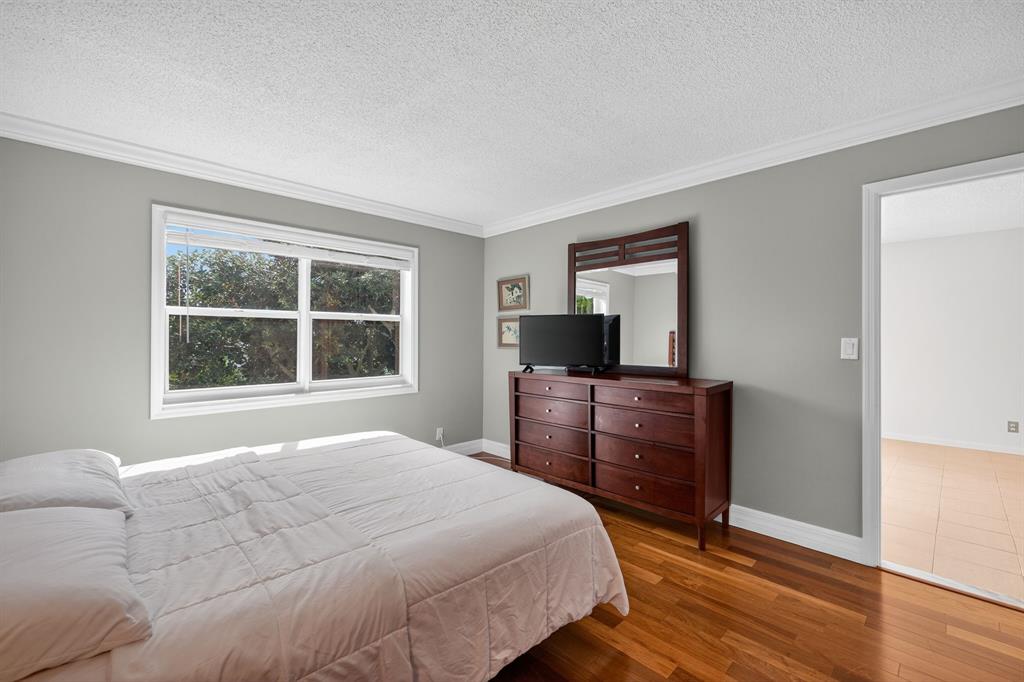 1541 South Ocean Boulevard, Unit 405 Lauderdale-by-the-Sea, FL 33062 - Photo 26 of 57 a bedroom with a bed and a window