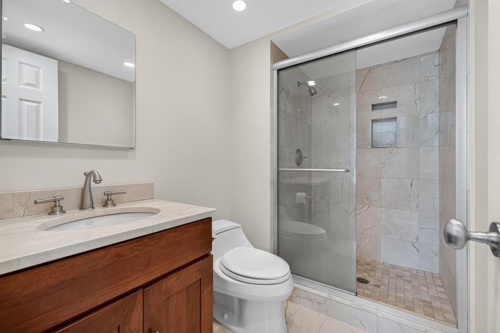 1541 South Ocean Boulevard, Unit 405 Lauderdale-by-the-Sea, FL 33062 - Photo 28 of 57 a bathroom with a sink a toilet and shower