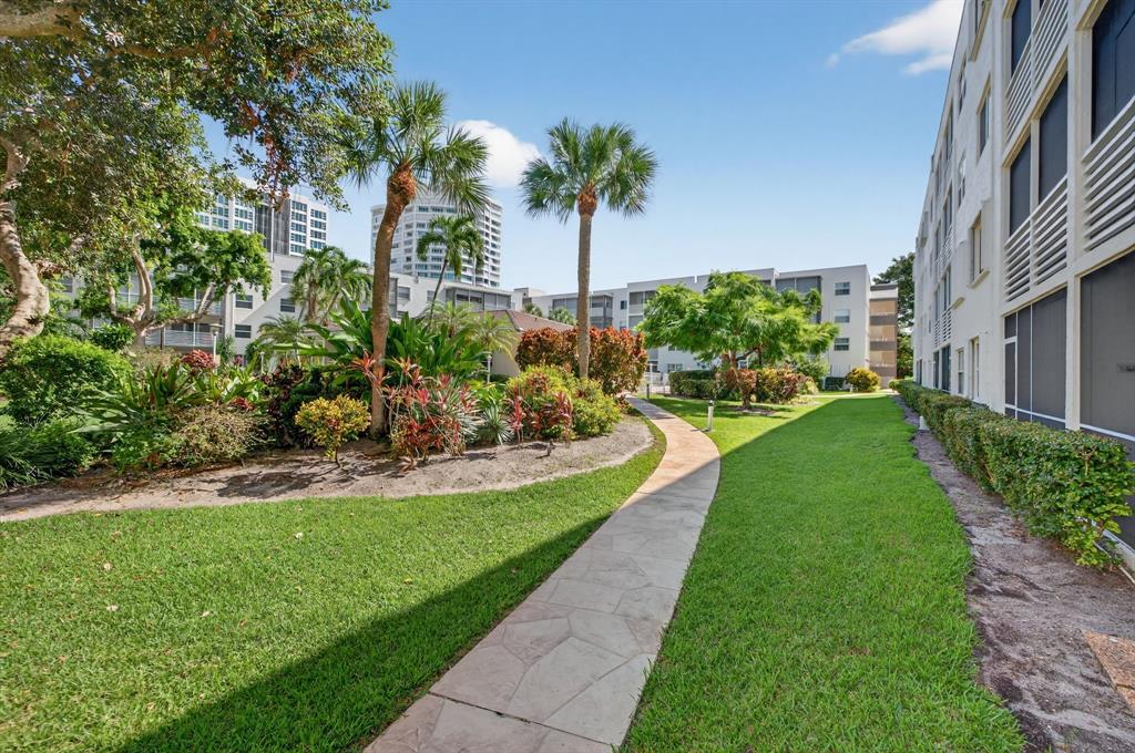 1541 South Ocean Boulevard, Unit 405 Lauderdale-by-the-Sea, FL 33062 - Photo 29 of 57 a view of a garden with a fountain