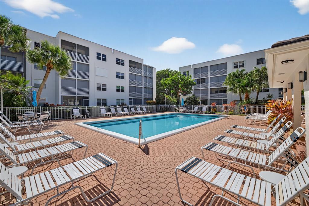 1541 South Ocean Boulevard, Unit 405 Lauderdale-by-the-Sea, FL 33062 - Photo 30 of 57 a building outdoor space with swimming pool and furniture