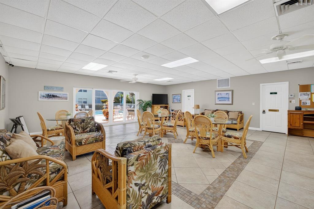 1541 South Ocean Boulevard, Unit 405 Lauderdale-by-the-Sea, FL 33062 - Photo 34 of 57 a living room with lots of furniture and a chandelier