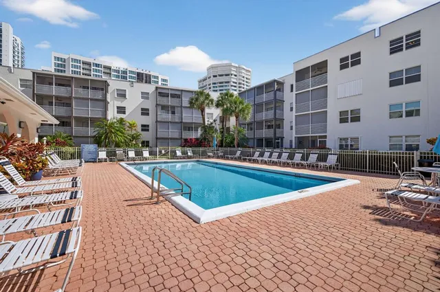 a view of multiple houses with swimming pool