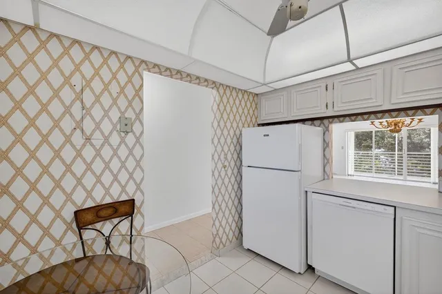 a kitchen with a stove cabinets and window