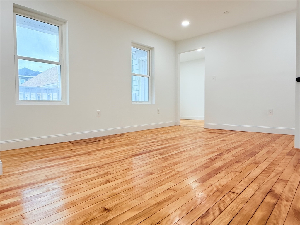 23 Bellevue Street, Unit 2 Worcester, MA 01609 - Photo 11 of 19 a view of empty room with wooden floor and fan