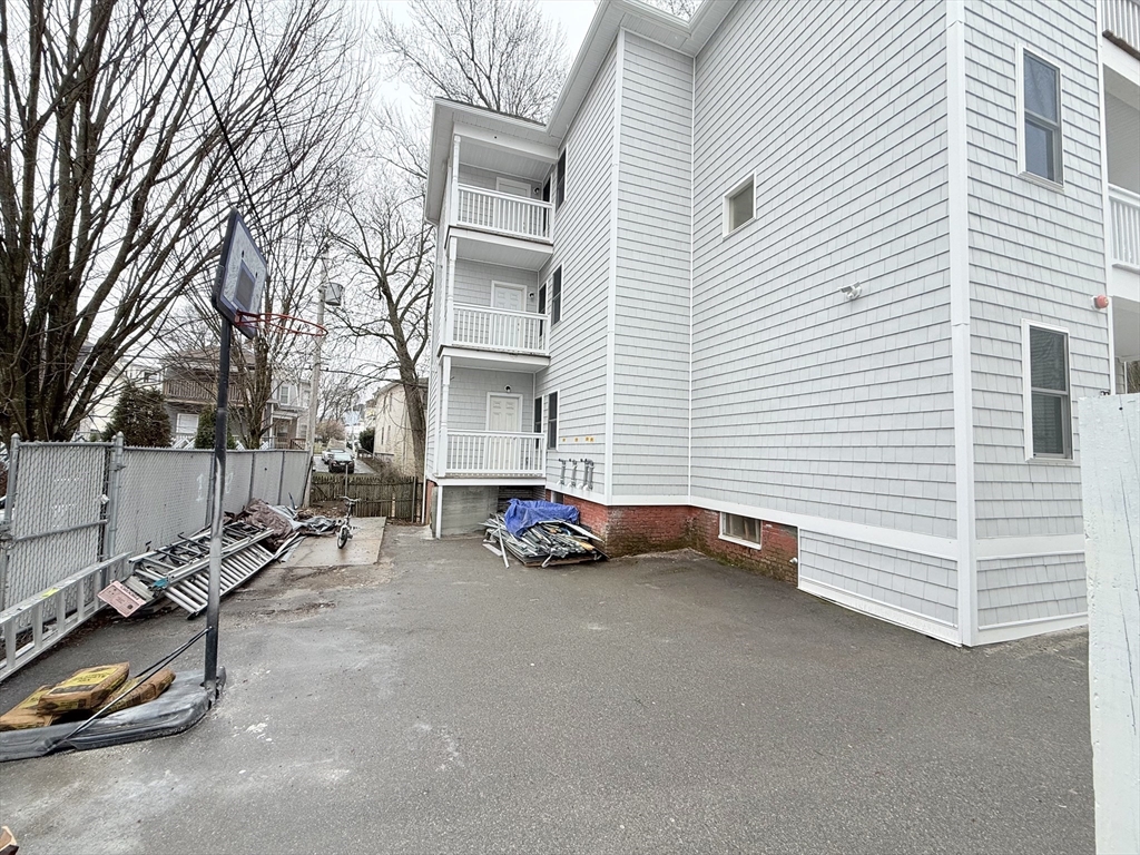 23 Bellevue Street, Unit 2 Worcester, MA 01609 - Photo 19 of 19 a view of a white house and a car parked on the road