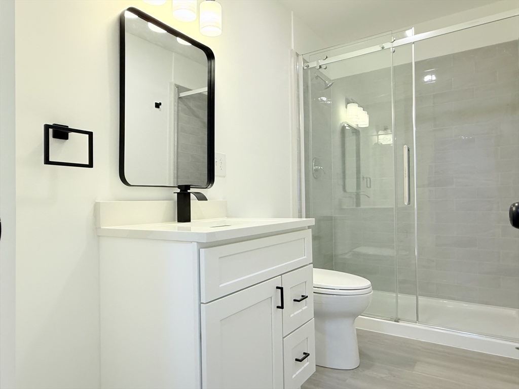 23 Bellevue Street, Unit 2 Worcester, MA 01609 - Photo 9 of 19 a bathroom with a sink a toilet and shower