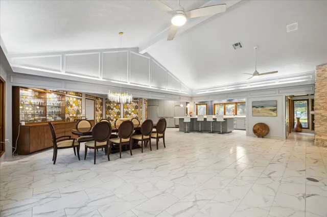 a dining room with furniture water view and balcony