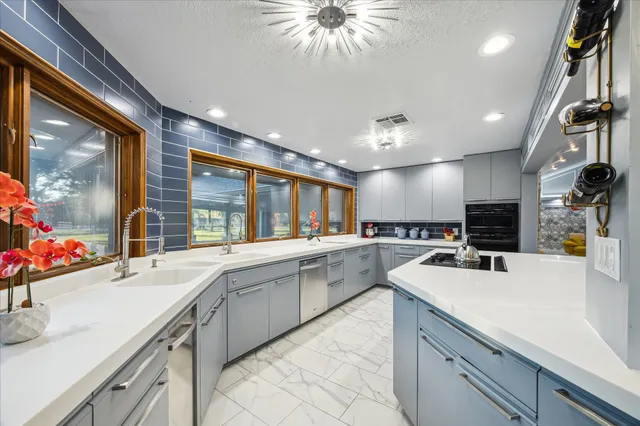 a kitchen with a sink stainless steel appliances and cabinets