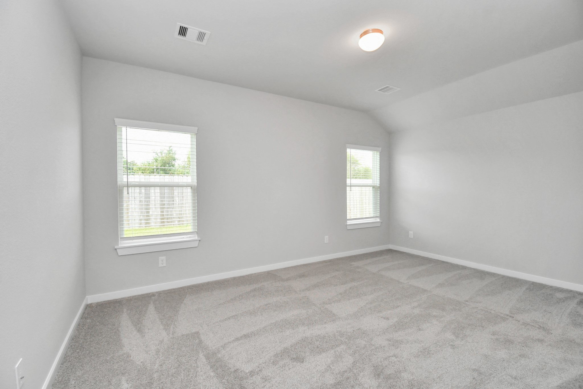 24611 Broad Park Spring, TX 77373 - Photo 17 of 25 Escape to tranquility in this spacious primary room, adorned with plush carpeting and bathed in the soothing hues of warm paint colors, creating a cozy retreat for relaxation. Sample photo of completed home with similar floor plan. Actual colors and selections may vary.