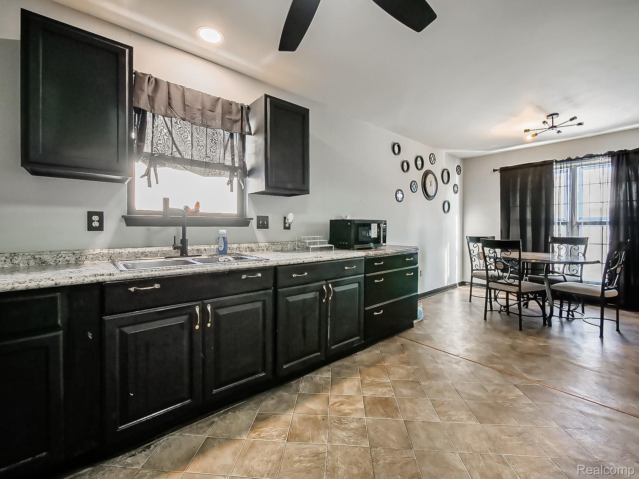 34460 Van Born Road Wayne, MI 48184 - Photo 5 of 31 Kitchen with dark cabinets and black microwave