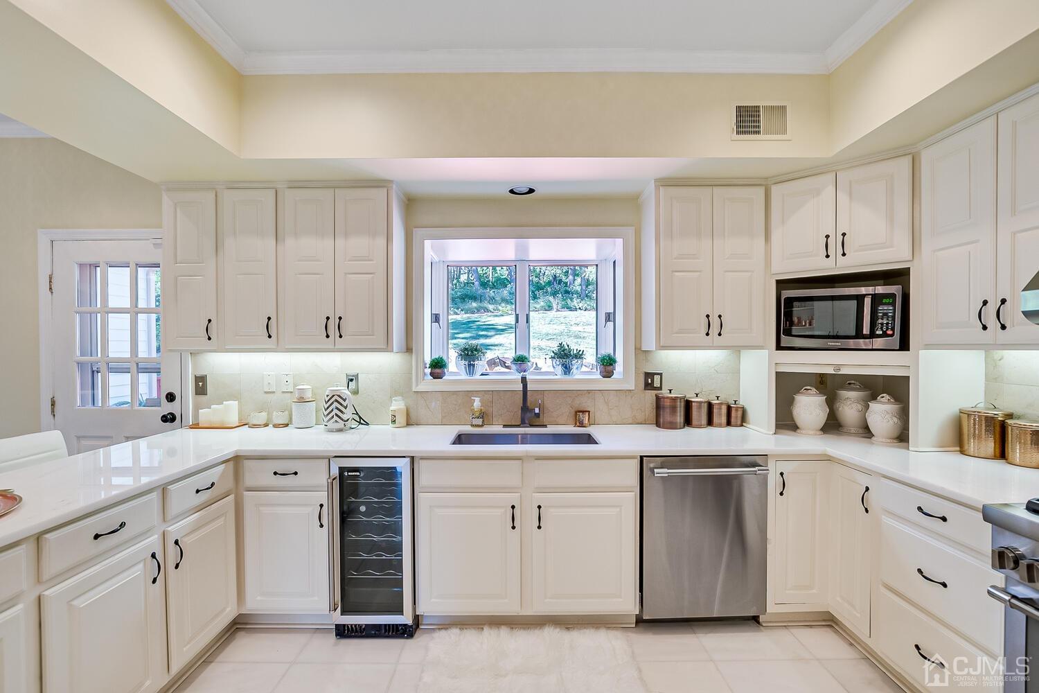 39 Martinsville Road Bernards, NJ 07920 - Photo 28 of 65 a kitchen with white cabinets appliances and a window