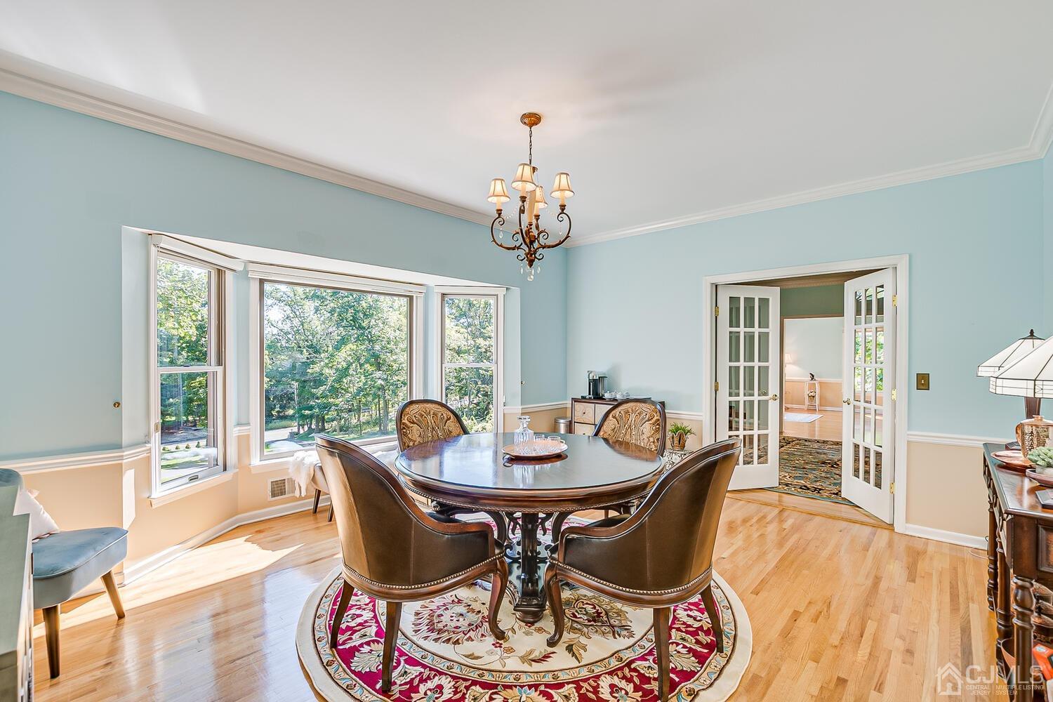 39 Martinsville Road Bernards, NJ 07920 - Photo 31 of 65 a dining room with furniture a chandelier and wooden floor