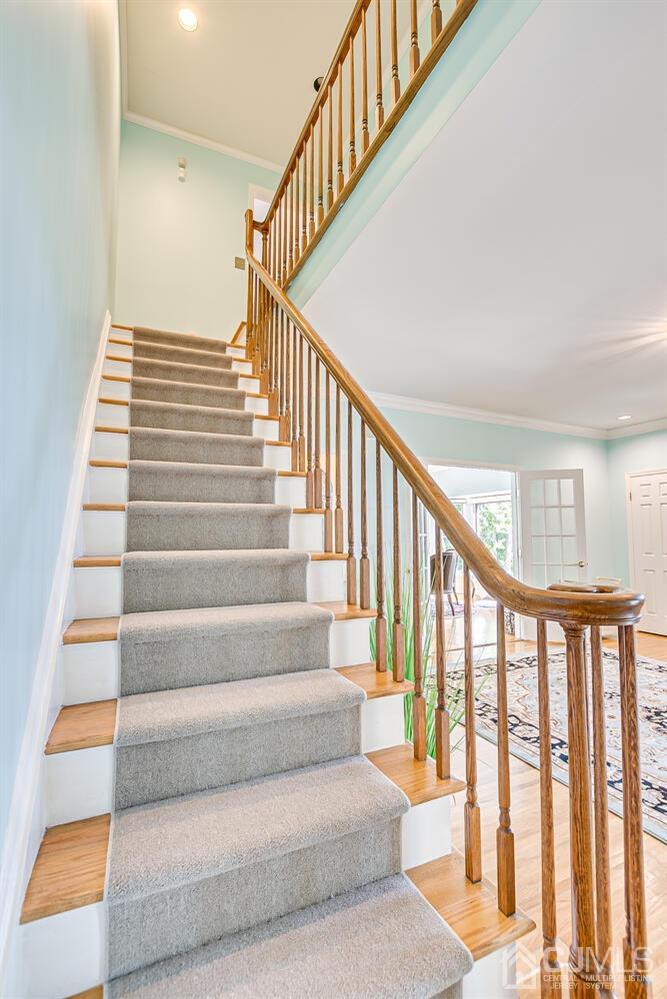 39 Martinsville Road Bernards, NJ 07920 - Photo 33 of 65 a view of staircase with lots of frames on wall and a window