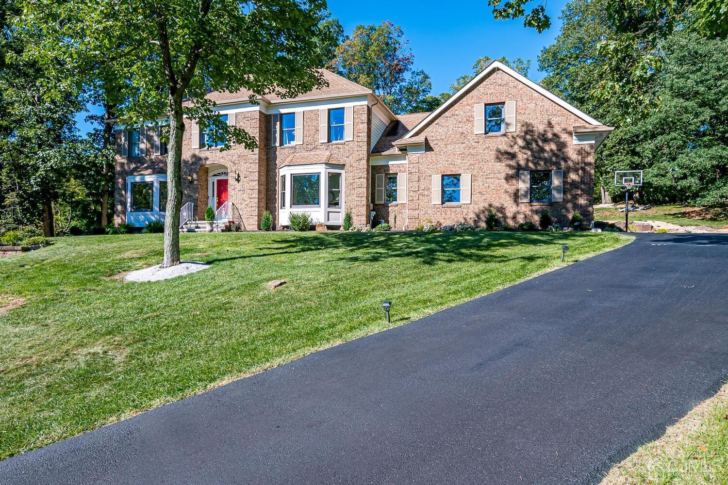 39 Martinsville Road Bernards, NJ 07920 - Photo 4 of 65 a front view of a house with a yard and garage