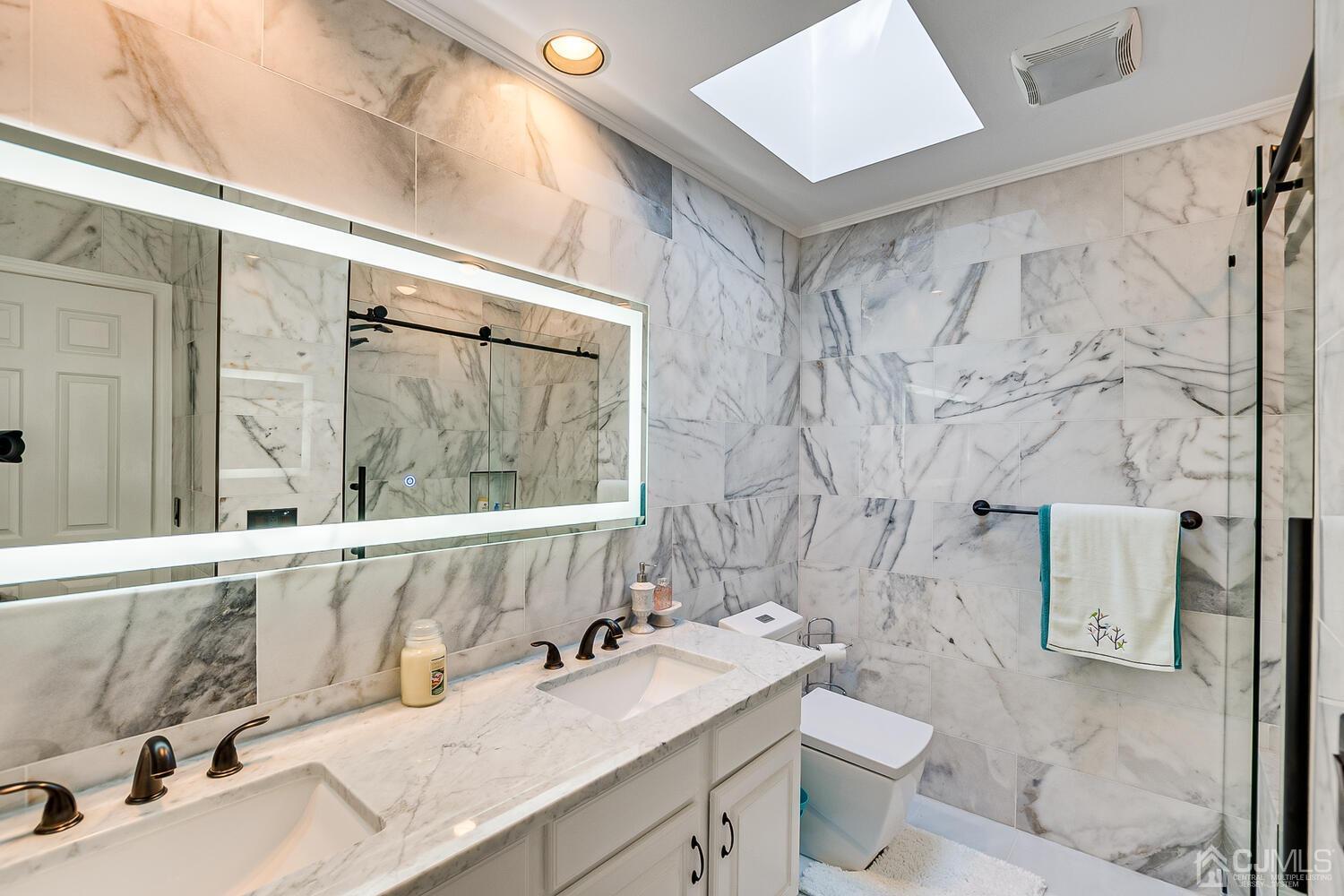 39 Martinsville Road Bernards, NJ 07920 - Photo 49 of 65 a bathroom with a granite countertop sink mirror vanity and toilet