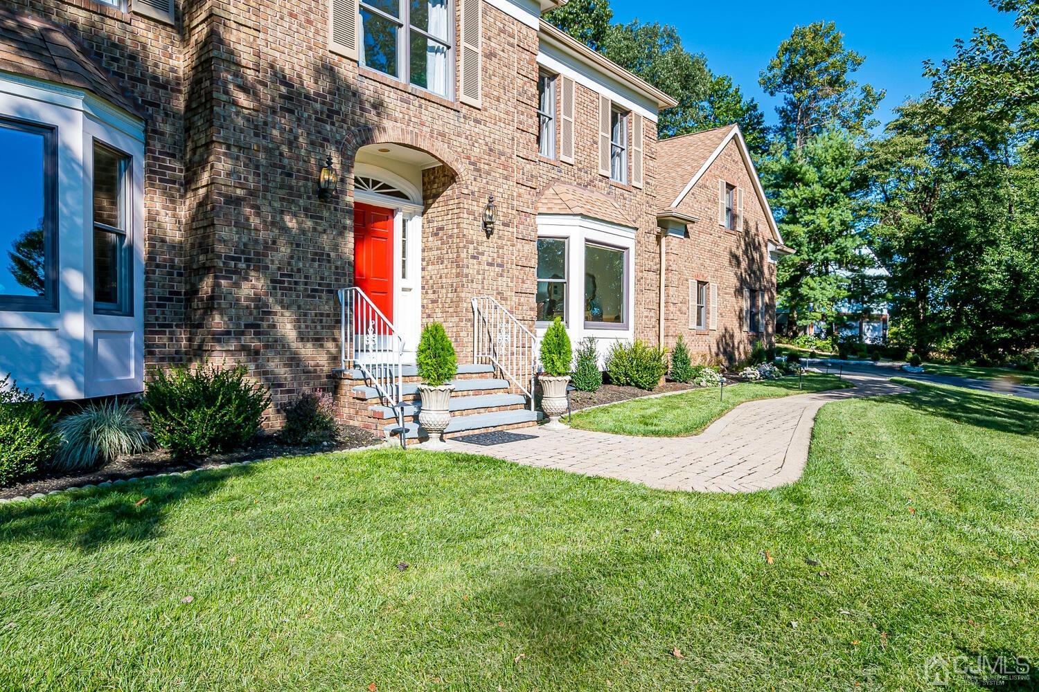 39 Martinsville Road Bernards, NJ 07920 - Photo 5 of 65 a front view of a house with a yard table and chairs