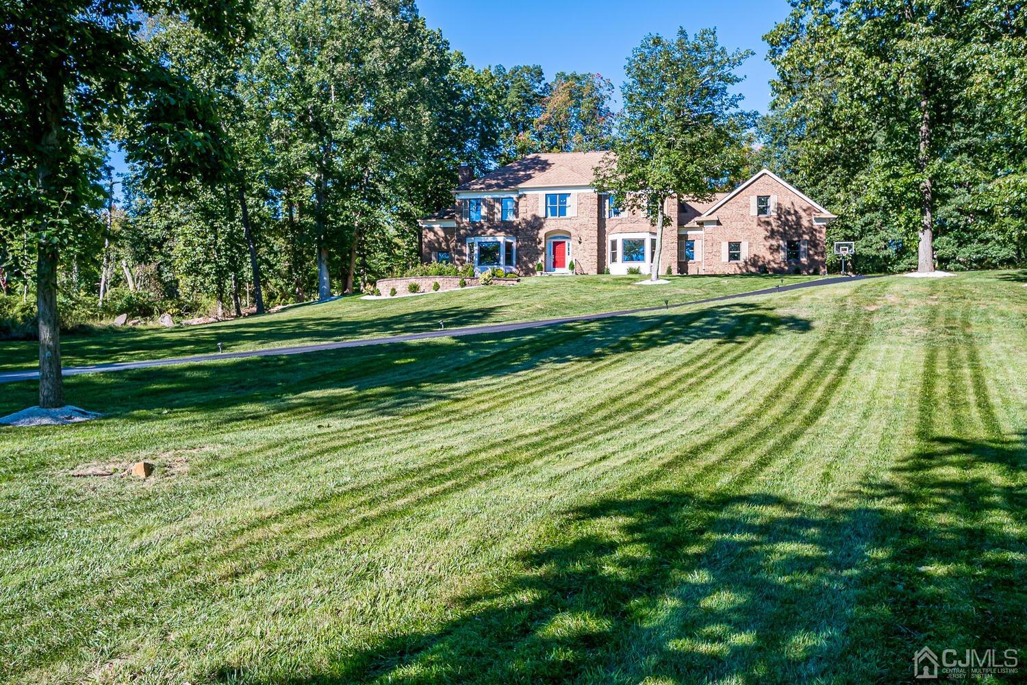 39 Martinsville Road Bernards, NJ 07920 - Photo 64 of 65 a front view of a house with a yard table and trees