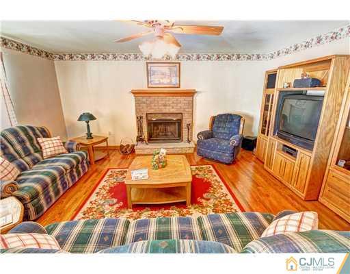 126 North Hill Road Colonia, NJ 07067 - Photo 11 of 25 a living room with furniture and a fireplace