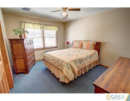 126 North Hill Road Colonia, NJ 07067 - Photo 18 of 25 a bedroom with a bed painting on wall and a large window