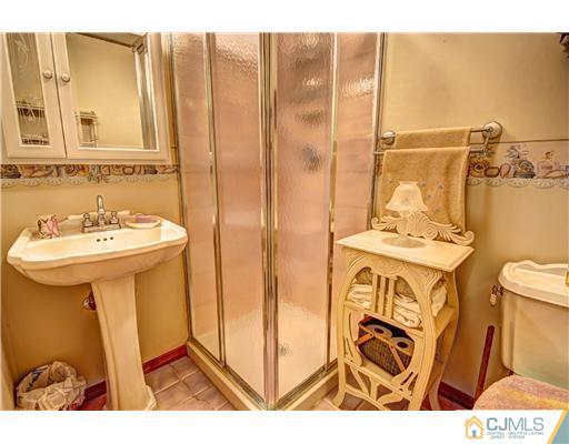 126 North Hill Road Colonia, NJ 07067 - Photo 23 of 25 a bathroom with a sink a toilet and shower