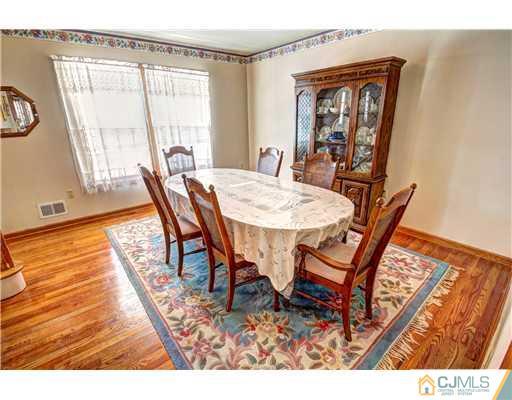 126 North Hill Road Colonia, NJ 07067 - Photo 4 of 25 a view of a dining room with furniture and wooden floor