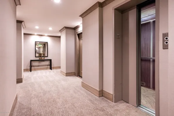 a view of hallway with stairs and furniture