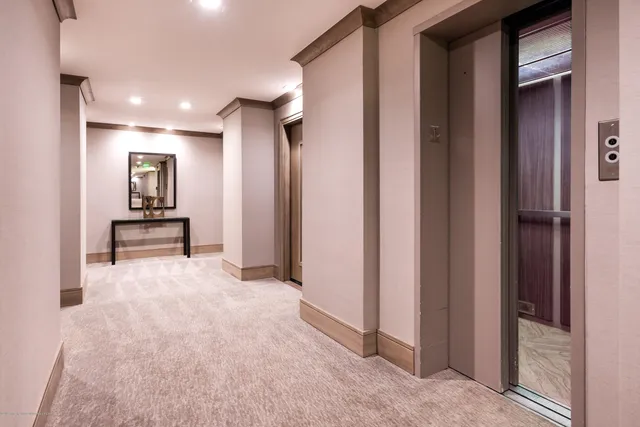 a view of hallway with stairs and furniture