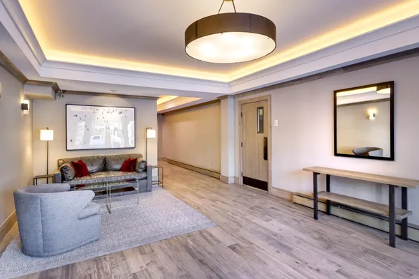 a living room with furniture and a wooden floor