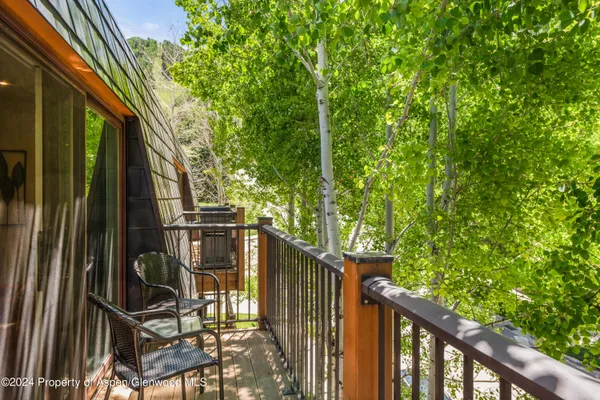 a view of balcony with wooden floor and fence