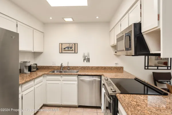 a kitchen with a sink stove and microwave