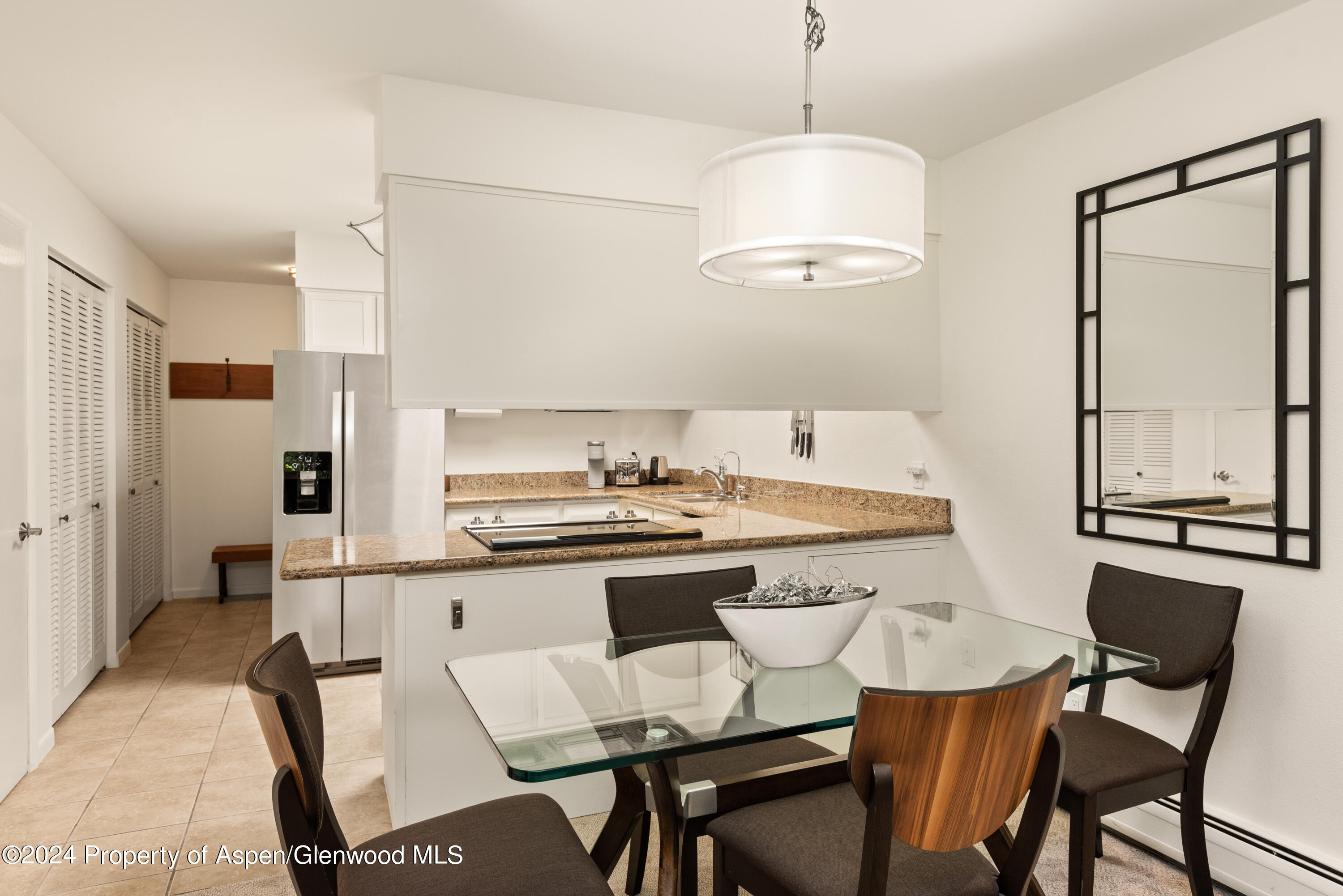 205 East Durant Avenue, Unit 3F Aspen, CO 81611 - Photo 6 of 20 a kitchen that has a cabinets and a stove in it