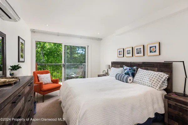 a bedroom with furniture and a large window