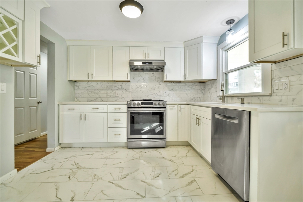16 Prospect Street Boston, MA 02136 - Photo 24 of 37 a kitchen with granite countertop a stove sink and cabinets