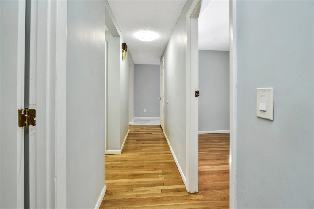 16 Prospect Street Boston, MA 02136 - Photo 26 of 37 a view of a hallway with wooden floor and staircase