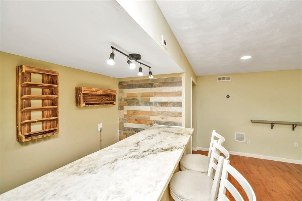 16 Prospect Street Boston, MA 02136 - Photo 30 of 37 a bedroom with a bed and furniture