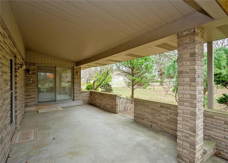 150 Crouse Road Greensburg, PA 15601 - Photo 19 of 25 PRIVATE COVERED SIDE PORCH OVER LOOKING THE LEVEL YARD.