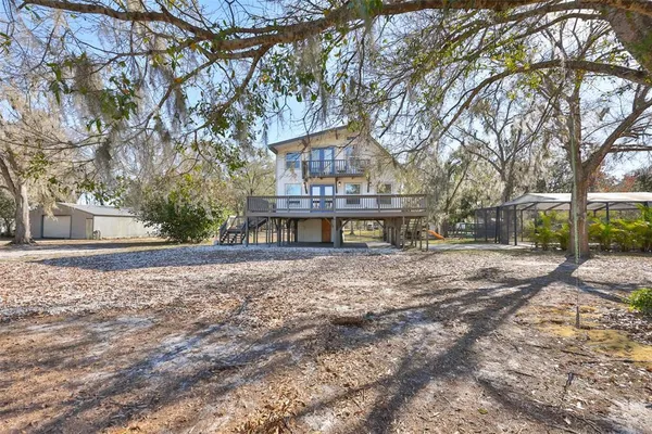 a view of a house with a yard and tree s
