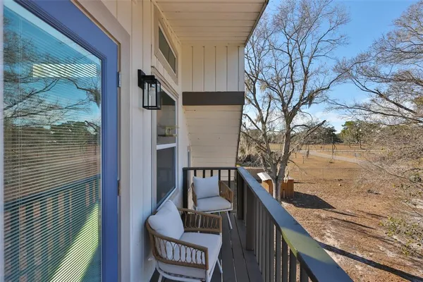 a view of balcony with wooden floor and fence