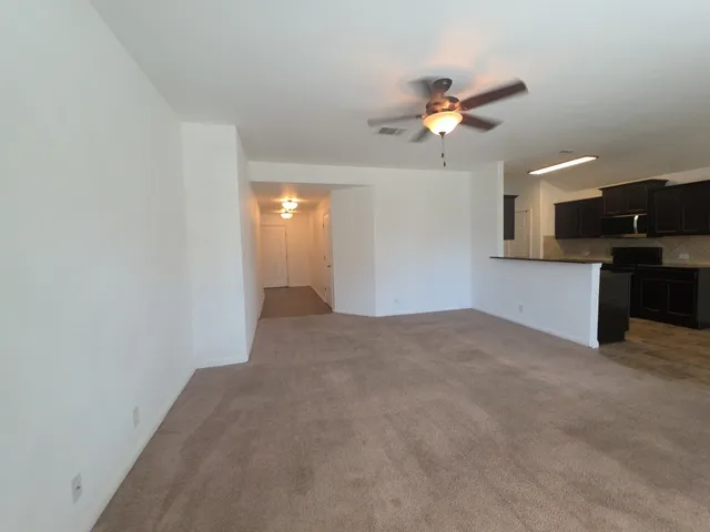a view of a kitchen with a sink and a chandelier fan