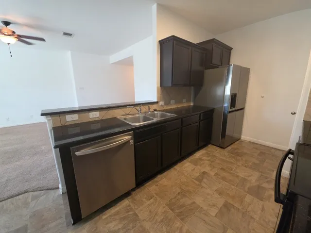a kitchen with stainless steel appliances granite countertop a stove and a refrigerator