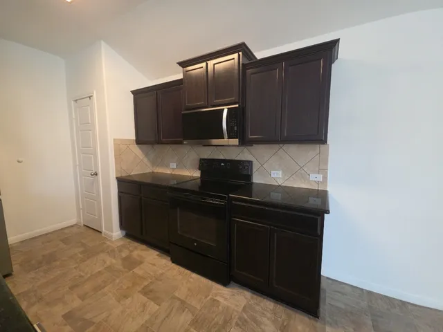 a kitchen with a sink and a microwave