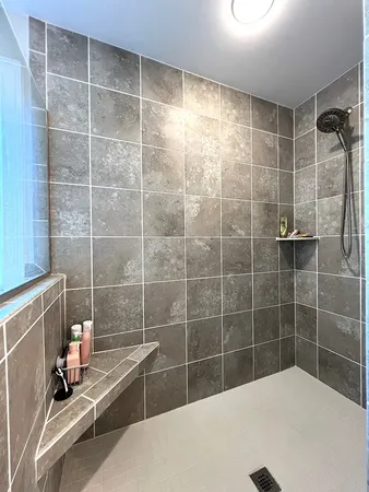 a living room with furniture a window and gym equipment